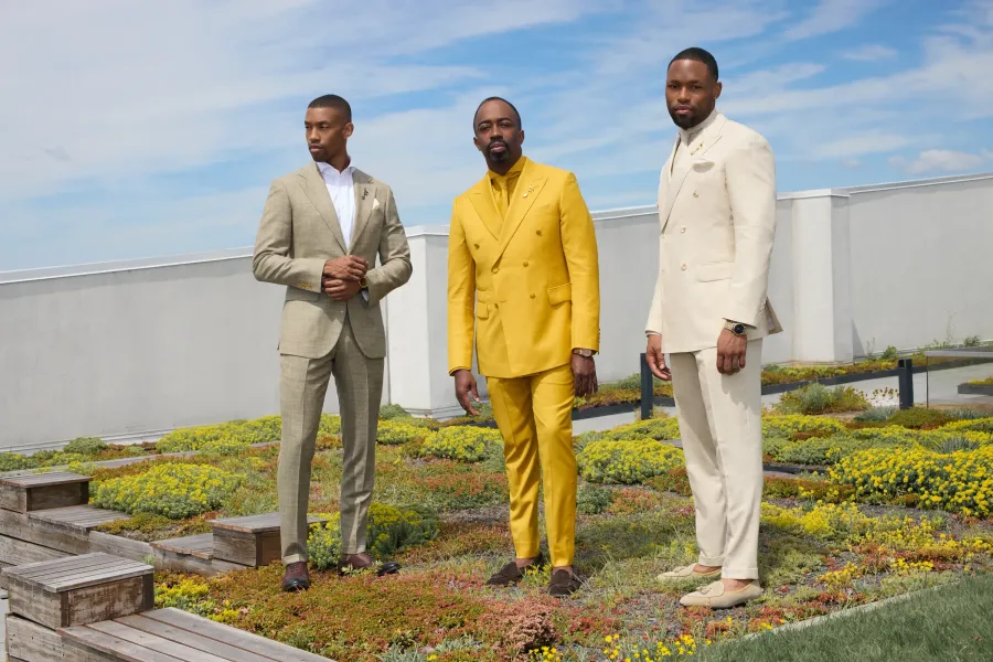 Three men in summer tailoring on a rooftop garden