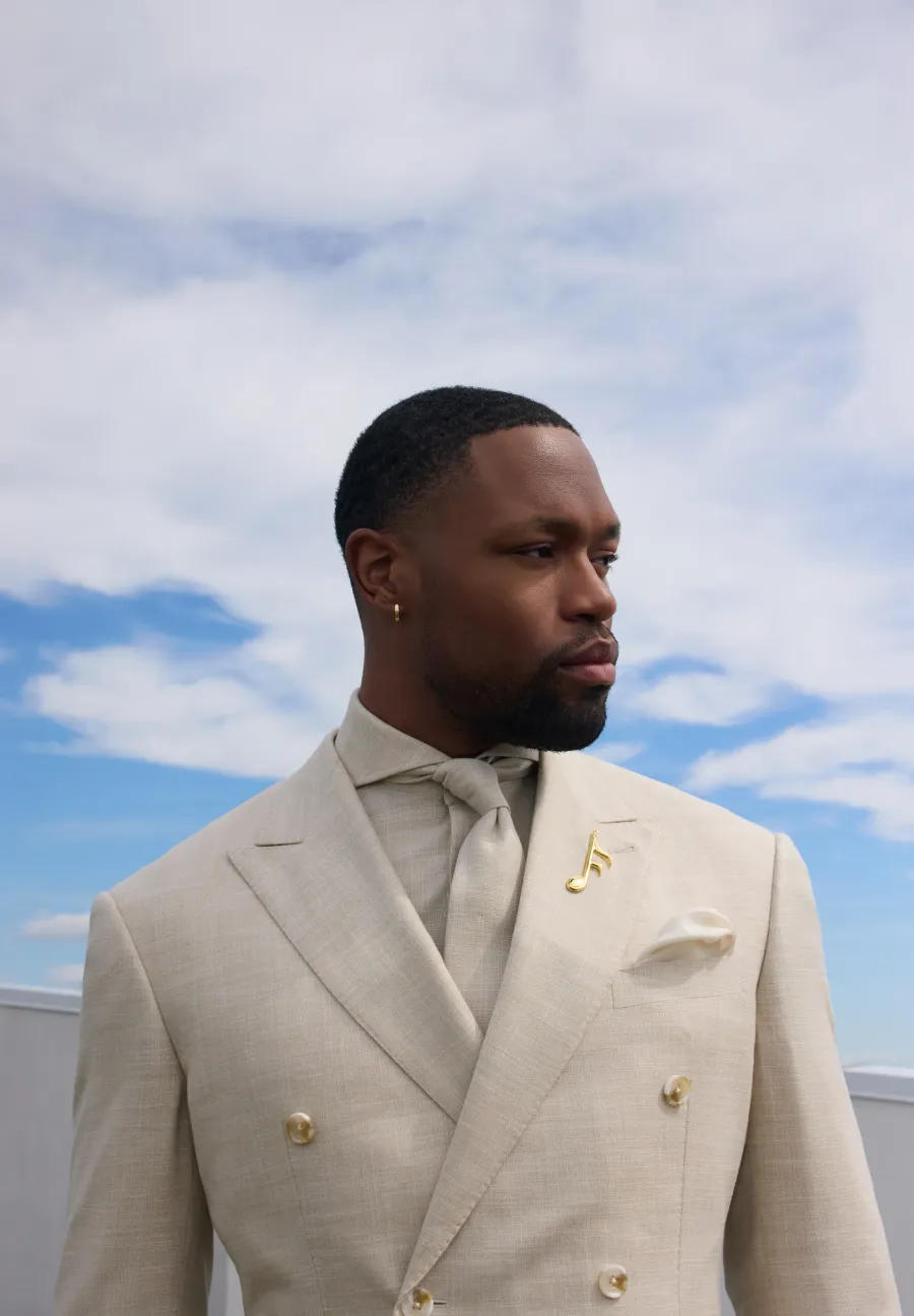 Ivory double-breasted suit against open sky