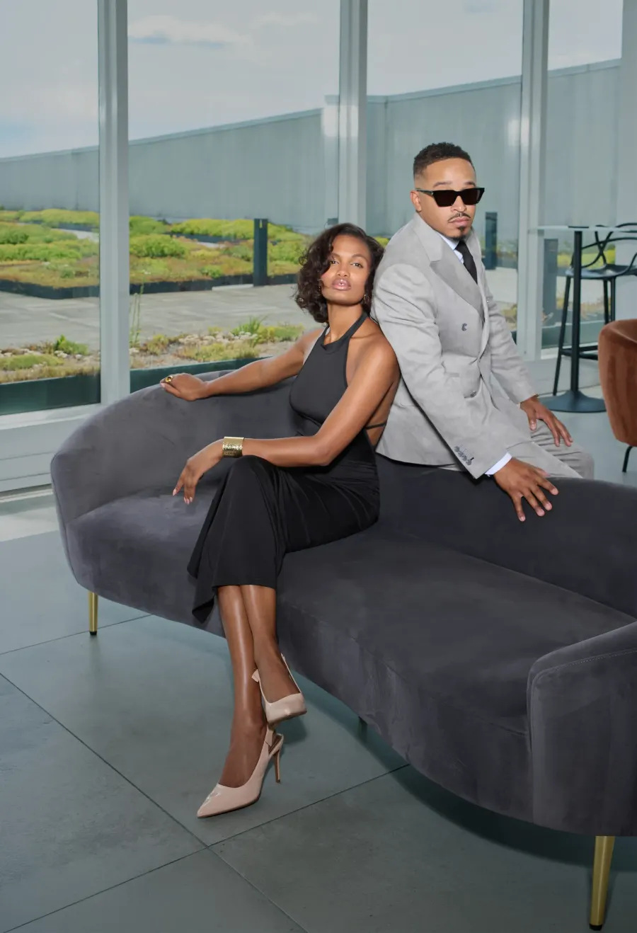 Rooftop terrace — grey double-breasted suit and black dress