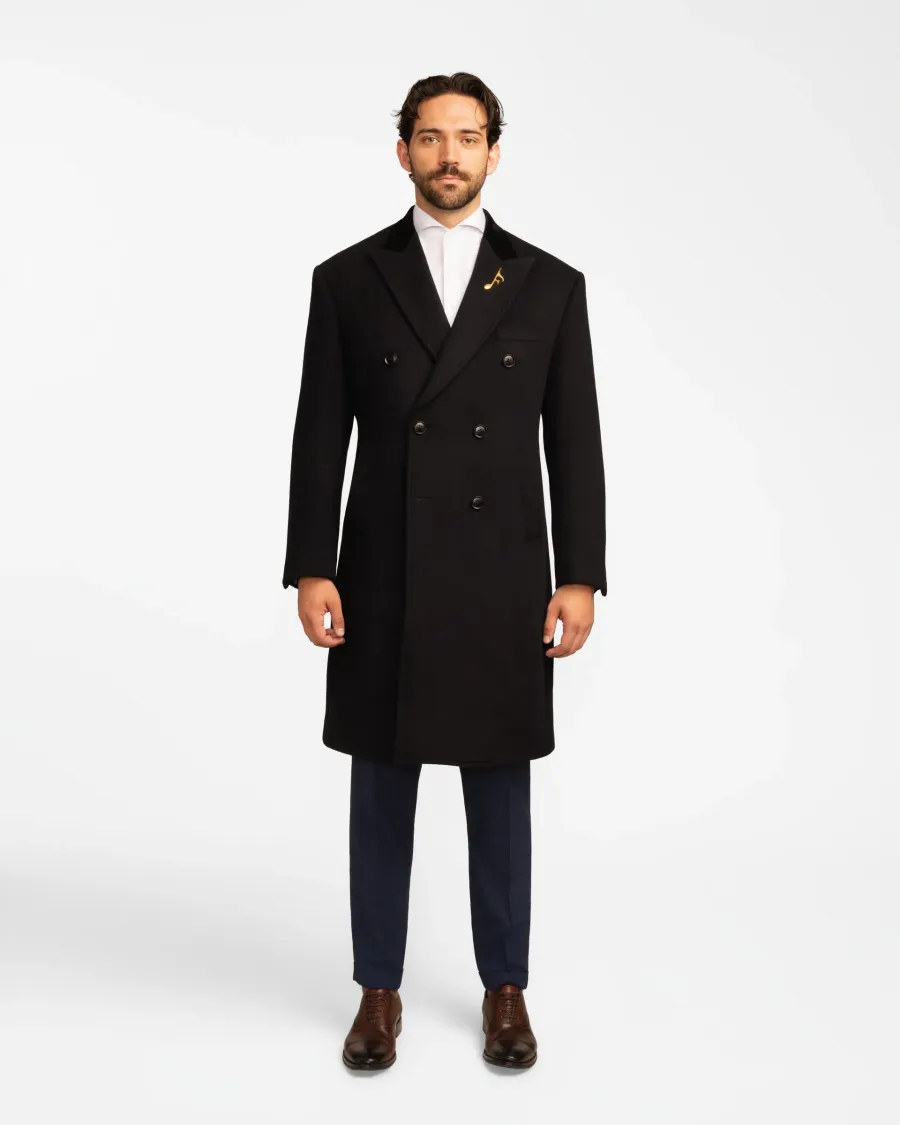 Black overcoat worn over navy trousers
